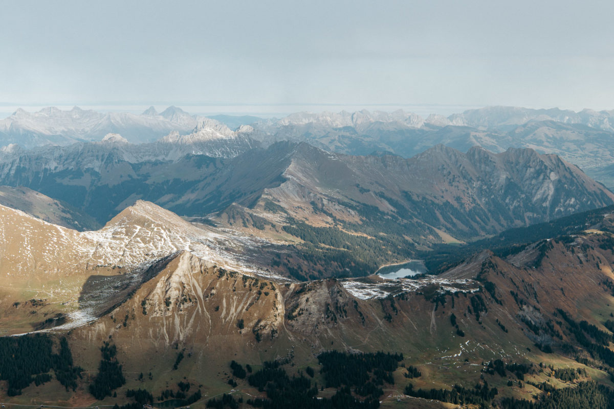 Vue entre hiver et printemps depuis le Peak Walk: Arnensee, Lac Retaud au tout premier plan et Gstaad à l'arrière-plan.